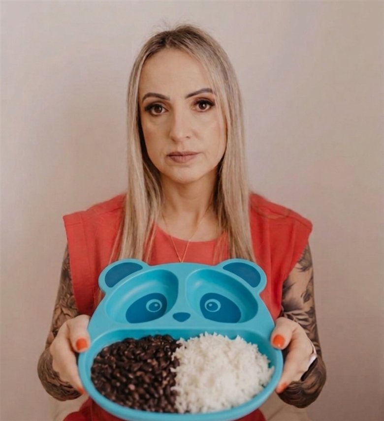 Rose Sodré segurando um prato infantil em formato de panda, com arroz e feijão